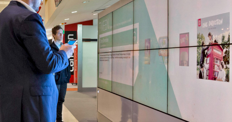 people looking at a video wall people looking at a video wall